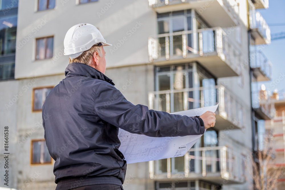 Construction manager with blueprints Construction manager with blueprints