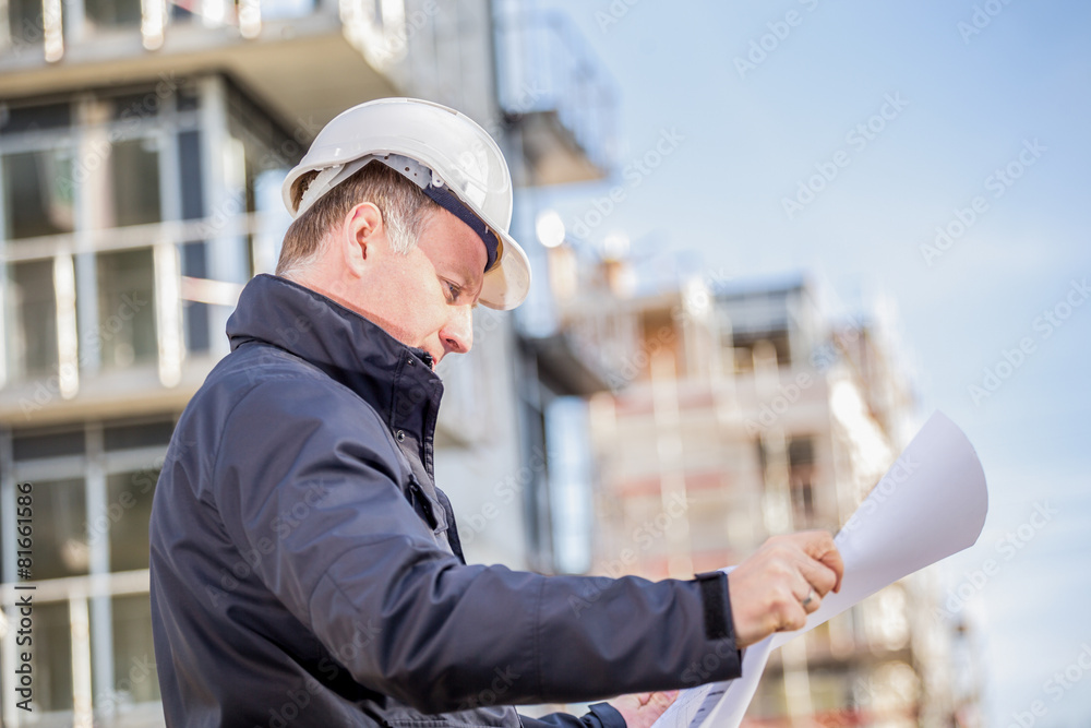 Construction manager with blueprints Construction manager with blueprints