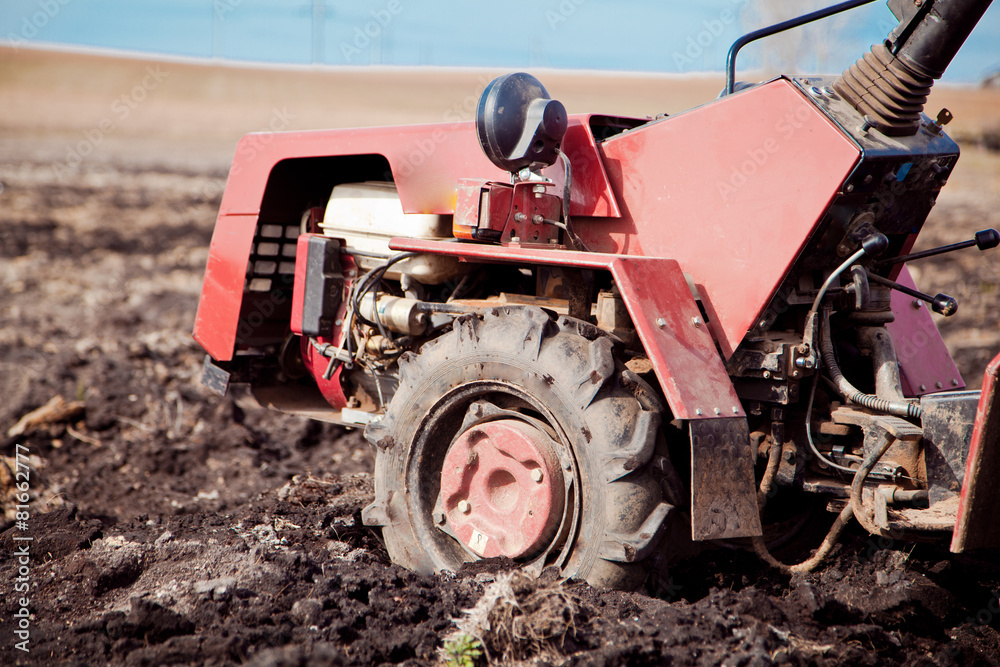 Little tractor a field in the spring Little tractor a field in the spring
