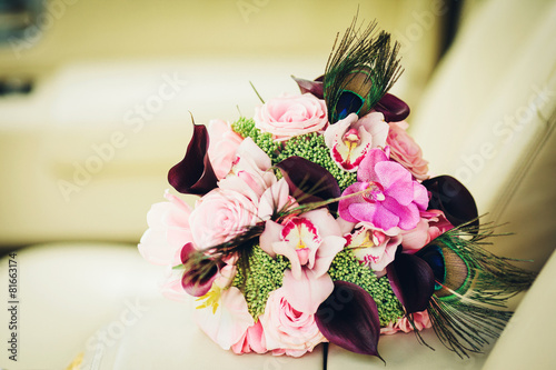 wedding bouquet with unusual flowers in hands of the bride