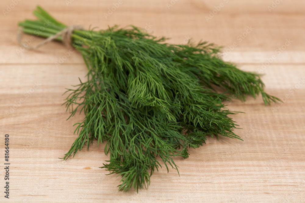 Bunch of fresh dill on a wooden board. Bunch of fresh dill on a wooden board.