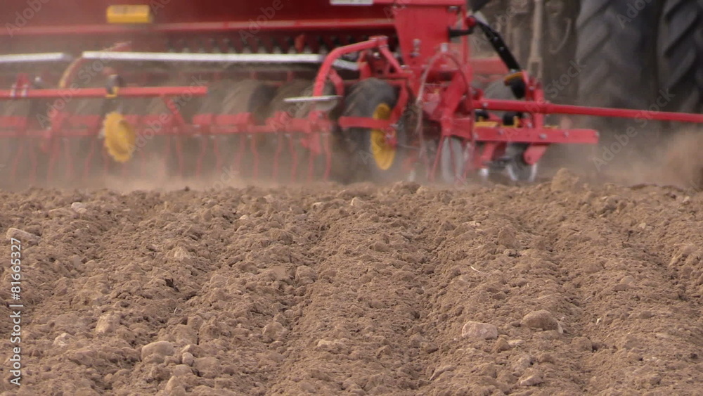 Soil and tractor fertilizing field. Heavy agricultural machinery Soil and tractor fertilizing field. Heavy agricultural machinery