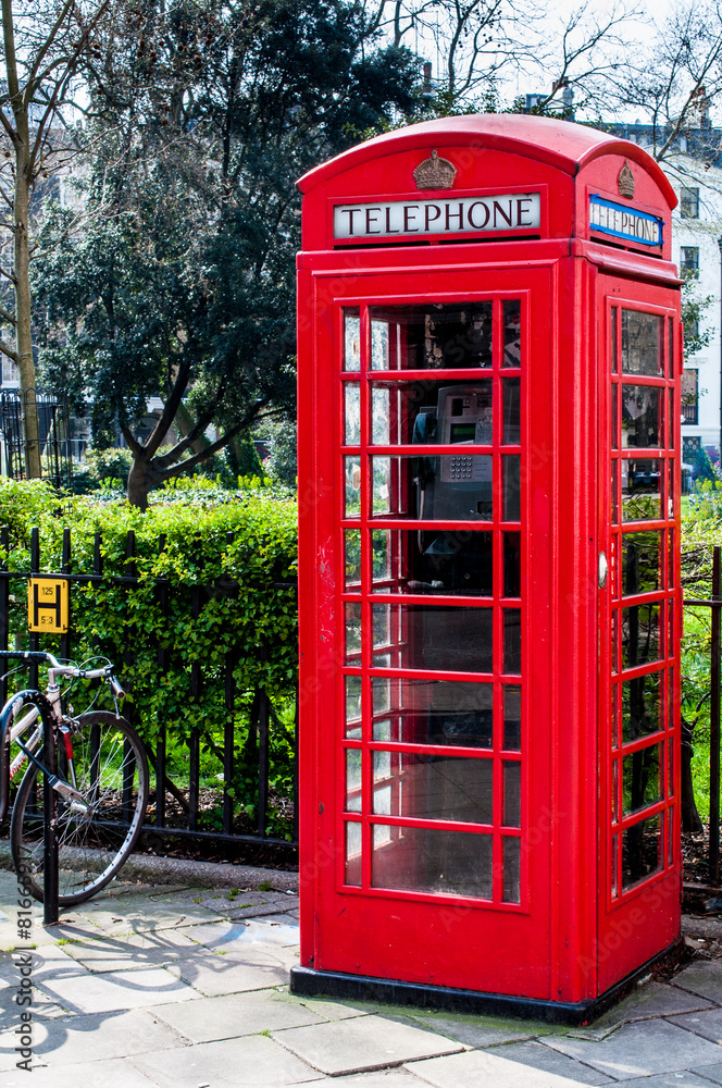 British Telecoms telephone box near a park in London British Telecoms telephone box near a park in London