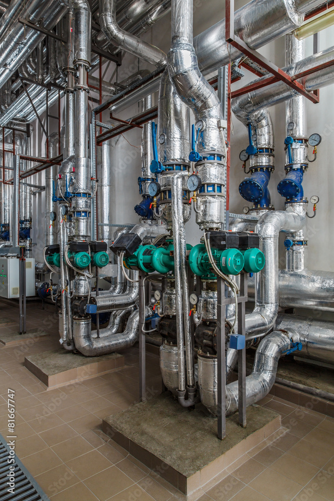 industrial boiler interior with lots of pipes, pumps and valves