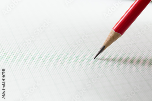 graph paper with red pencil photo