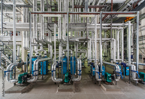 industrial boiler interior with lots of pipes, pumps and valves