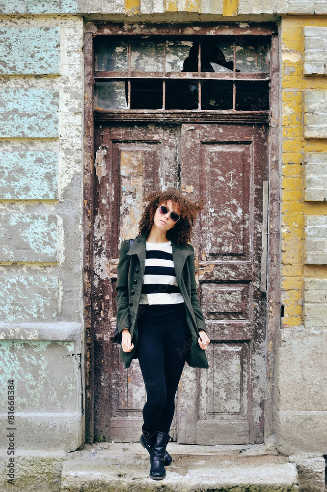 Attractive young woman in sunglasses posing outdoor. Full body p Attractive young woman in sunglasses posing outdoor. Full body p