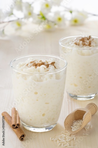 Milk rice pudding desserts in a glass with cinnamon sprinkles