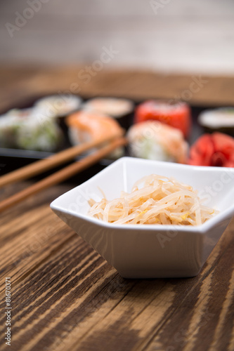 Fresh platter of bean sprouts with chopsticks on wooden table