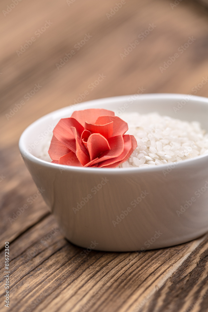 Platter of sushi rise with flower on wooden table Platter of sushi rise with flower on wooden table