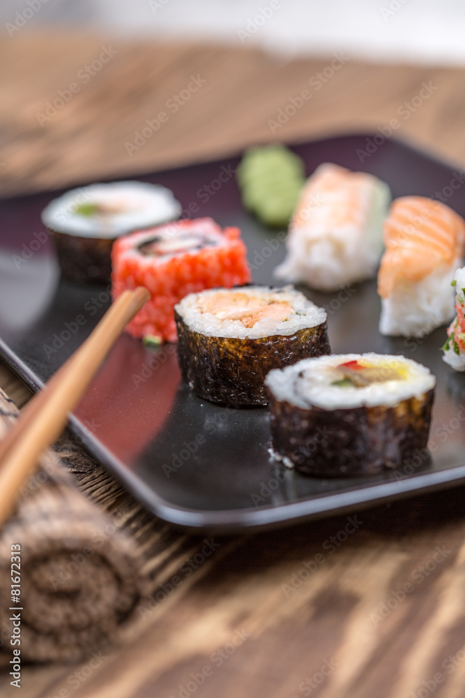 fresh Japanese tasty sushi roll set with chopsticks on wooden ta fresh Japanese tasty sushi roll set with chopsticks on wooden ta