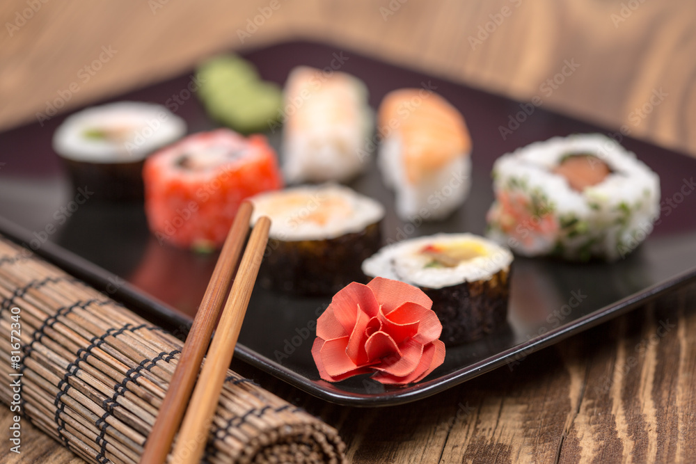 fresh Japanese tasty sushi roll set with chopsticks on wooden ta fresh Japanese tasty sushi roll set with chopsticks on wooden ta