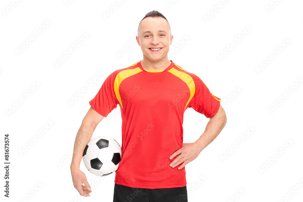 Football player holding a ball and smiling Football player holding a ball and smiling