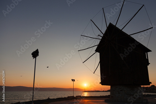 Black silhouette in the morning sun. Old windmill, Nessebar