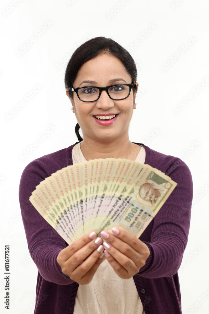 Excited successful young woman holding Indian rupee bills Excited successful young woman holding Indian rupee bills