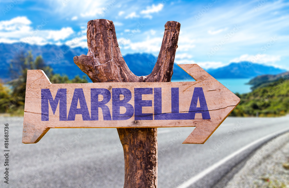 Marbella wooden sign with road background