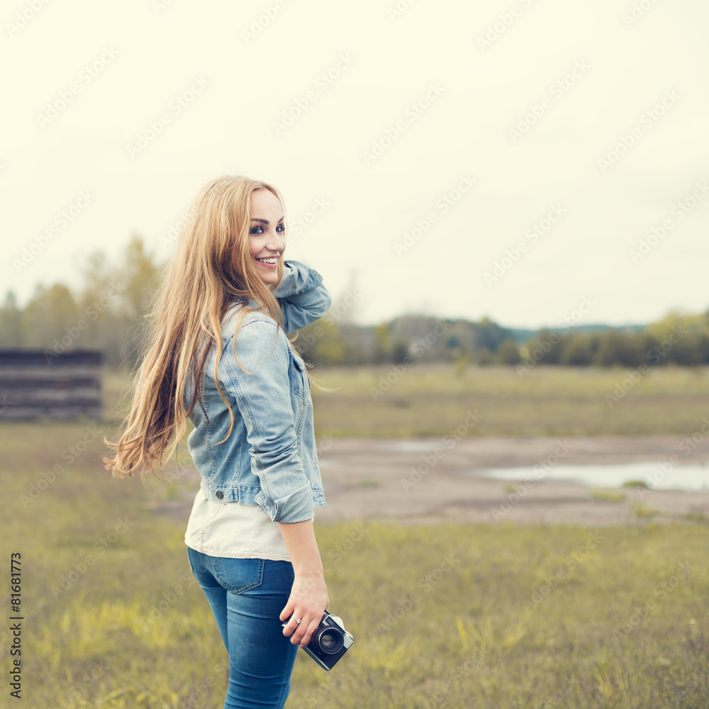 beautiful girl with vintage camera outdoors