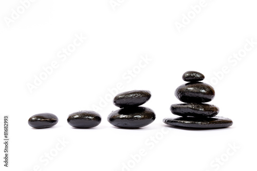 Black wet stones on white background