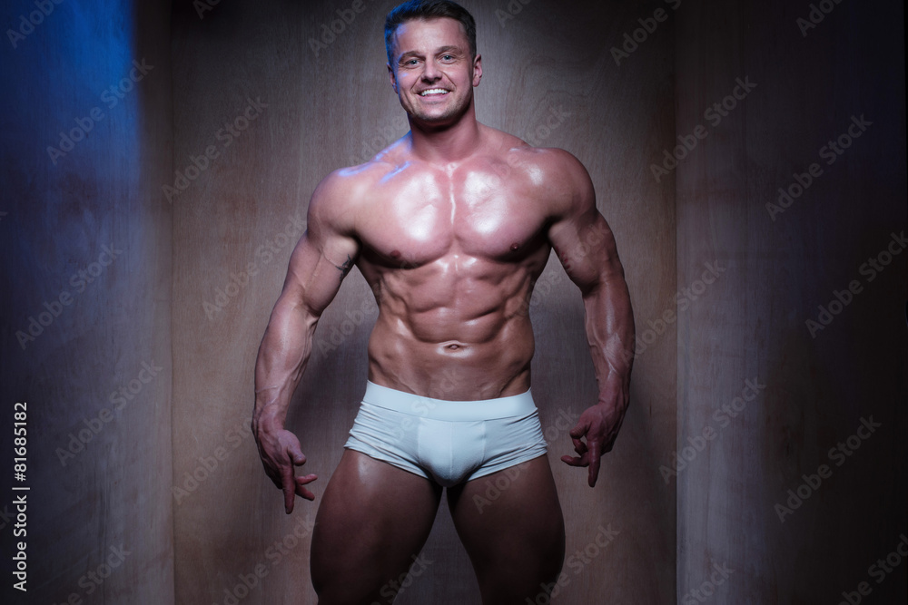 Fototapeta premium Muscular Man in White Boxer Shorts Looking Down