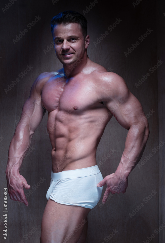 Fototapeta premium Muscular Man in White Boxer Shorts Looking Down