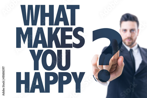 Business man pointing the text: What Makes You Happy?