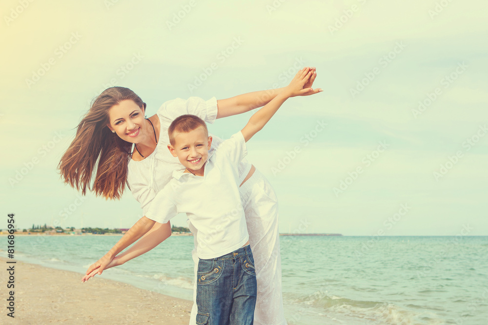 Mother and her son having fun on the beach