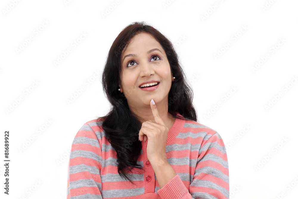 Young female teenager looking up against white background Young female teenager looking up against white background