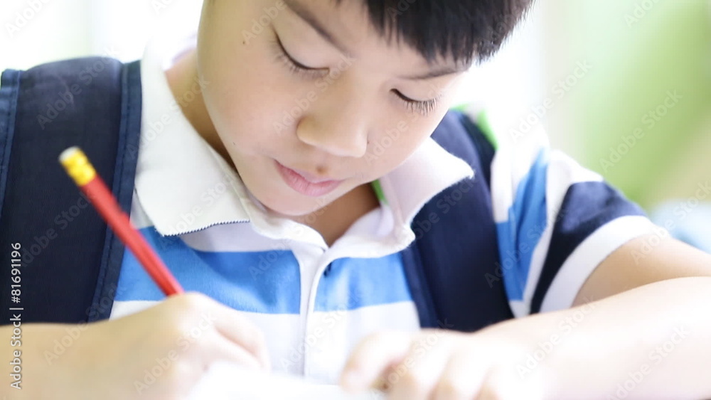 Asian cute child with pencil ,to do homework at home Asian cute child with pencil ,to do homework at home