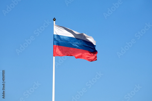Russian flag on the flagpole waving on sky