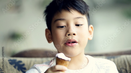 Little asian cute boy enjoy eating an ice cream