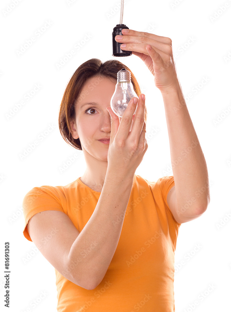 Fototapeta premium girl change a light bulb