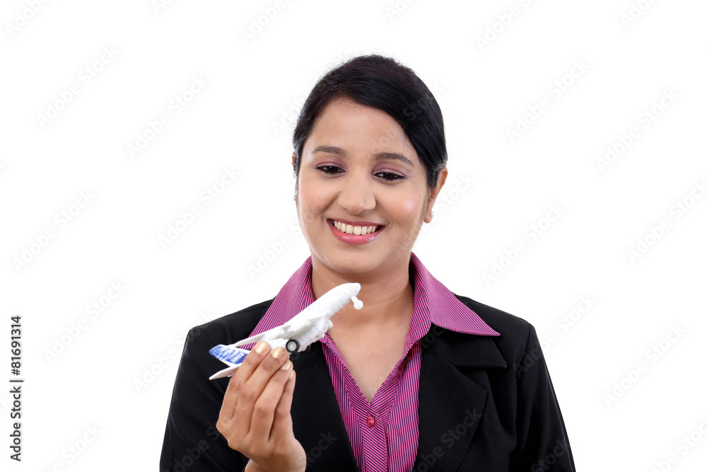 Cheerful businesswoman holding airplane miniature Cheerful businesswoman holding airplane miniature