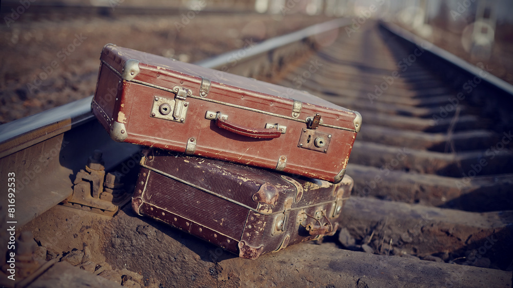The image of vintage suitcases thrown on railway tracks.