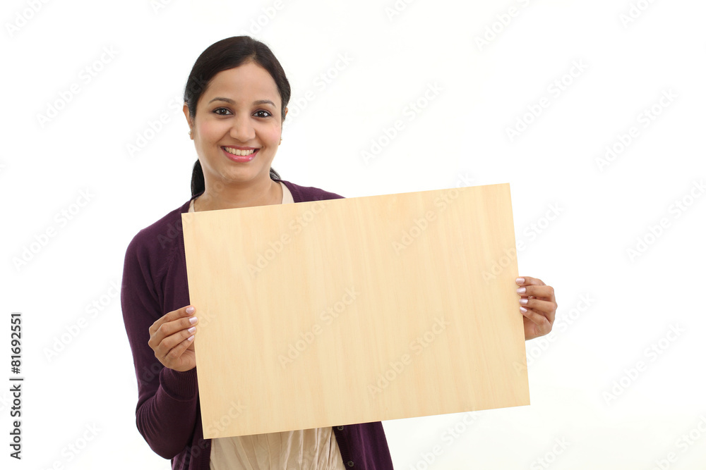 Smiling young Woman holding blank wood sheet Smiling young Woman holding blank wood sheet