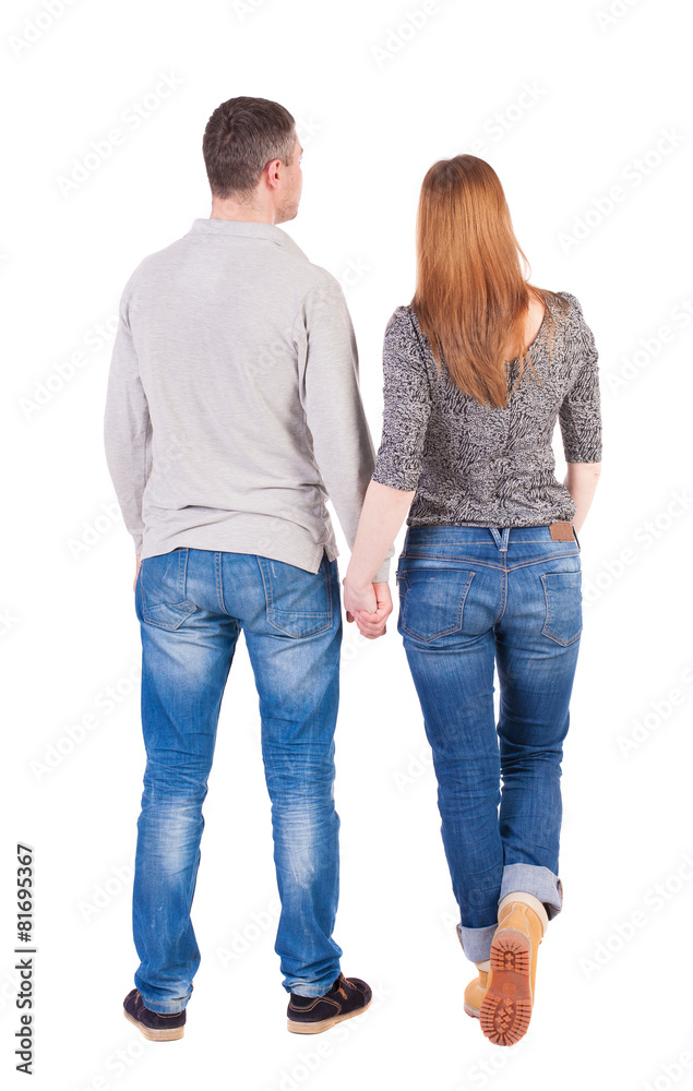 Back view of young embracing couple (man and woman) hug and look Back view of young embracing couple (man and woman) hug and look