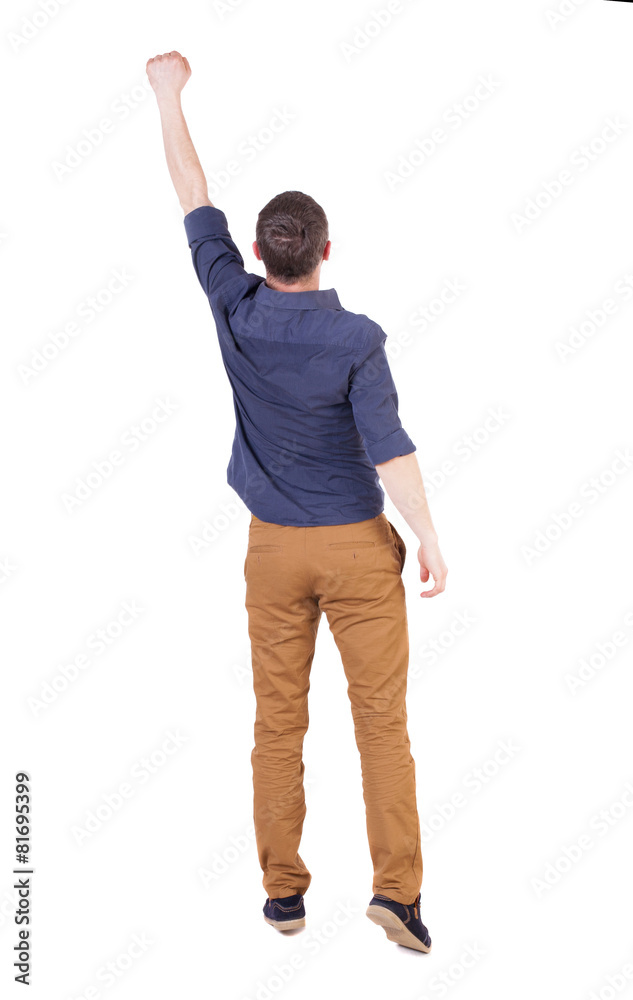 Back view of man in checkered shirt Raised his fist up in victo Back view of man in checkered shirt Raised his fist up in victo