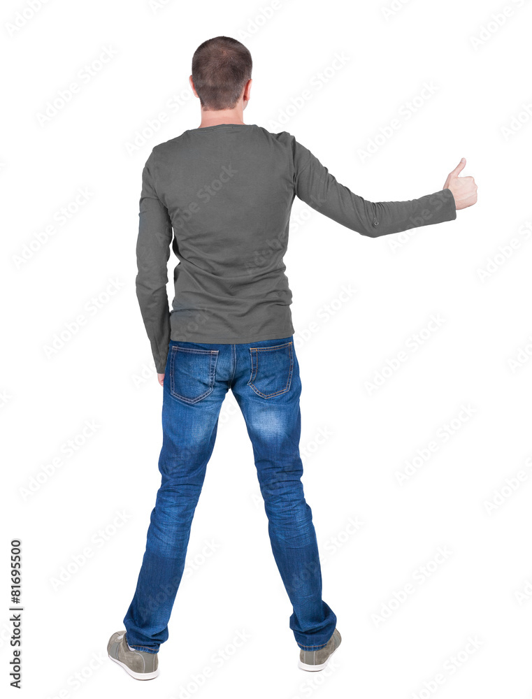Back view of man in t-shirt. shows thumbs up. Back view of man in t-shirt. shows thumbs up.