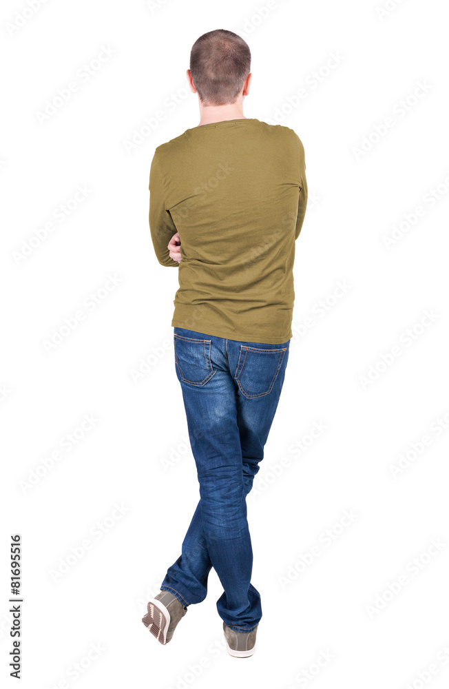 Back view of young man in t-shirt and jeans looking. Back view of young man in t-shirt and jeans looking.