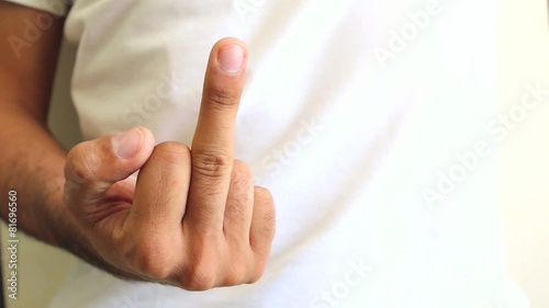 hand giving middle finger. offensive gesture. close up