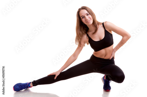 Young healthy girl stretching on white background