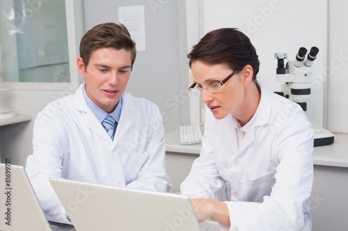 Scientists working attentively with laptop © WavebreakmediaMicro