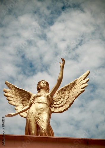 Winged angel statue isolated on sky