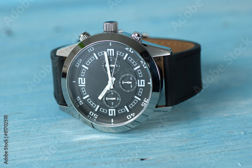 Wristwatch on old wooden table