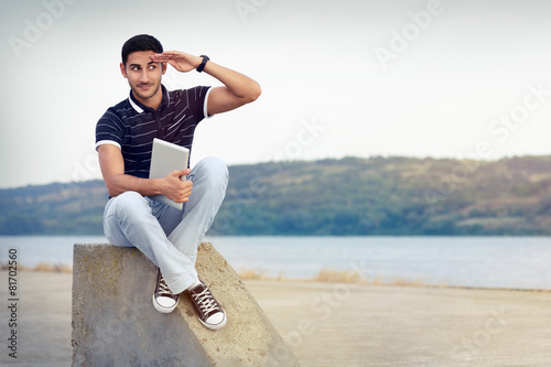 Young Man with Sunglasses and Tablet by the Water