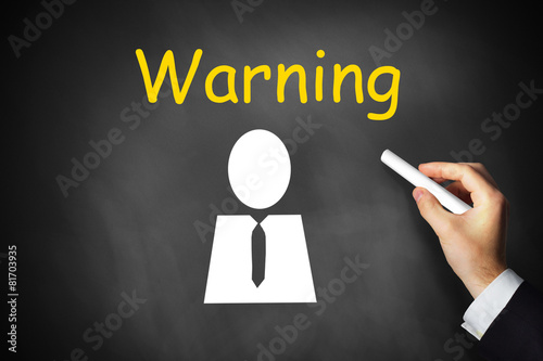 hand writing warning on black chalkboard photo