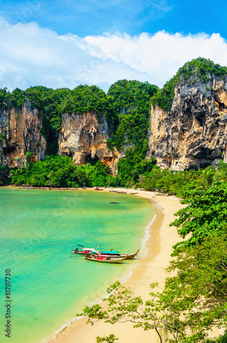 Amazing Railay Beach with mogotes, long tail boat and high palm