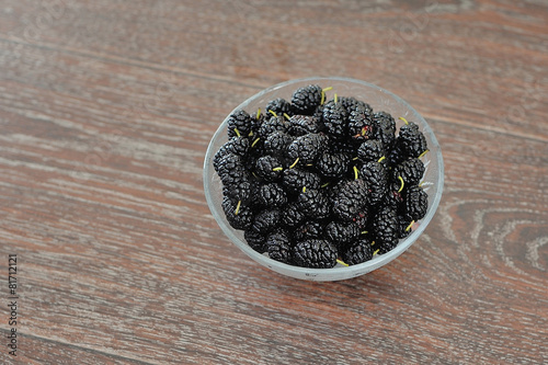 piala in black mulberry pile on a wooden background photo