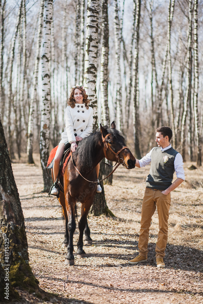 romantic walk of bride and groom, woman riding brown horse romantic walk of bride and groom, woman riding brown horse