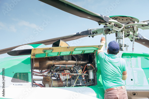 Engineer maintaining a helicopter Engine