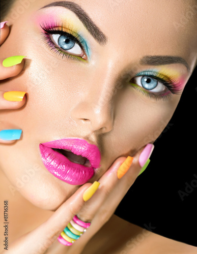 Beauty girl face with vivid makeup and colorful nail polish